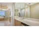 Spacious main bathroom with dual vanities, a soaking tub, glass shower, and tile floors at 2050 Benjamin Franklin Dr # B603, Sarasota, FL 34236