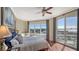 Bedroom with large windows, hardwood floors, and coastal decor at 2050 Benjamin Franklin Dr # B603, Sarasota, FL 34236