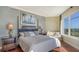 Large main bedroom with wood floors, windows, a sitting area, and coastal decor at 2050 Benjamin Franklin Dr # B603, Sarasota, FL 34236