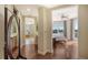 Hallway leading to the bedroom with wood floors and a view of the bathroom at 2050 Benjamin Franklin Dr # B603, Sarasota, FL 34236