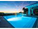 Illuminated community pool at dusk with ample space for swimming and lounging at 2050 Benjamin Franklin Dr # B603, Sarasota, FL 34236
