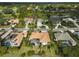 Wide aerial view of community with a focus on one home at 2112 Calusa Lakes Blvd, Nokomis, FL 34275