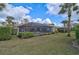 Landscaped backyard with a screened pool and patio area at 2112 Calusa Lakes Blvd, Nokomis, FL 34275