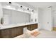 Double vanity bathroom with dark wood cabinets and modern fixtures at 2112 Calusa Lakes Blvd, Nokomis, FL 34275