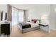 Bright bedroom with a gray upholstered bed and wood floors at 2112 Calusa Lakes Blvd, Nokomis, FL 34275