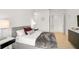 Spacious bedroom with gray upholstered bed and ensuite bathroom at 2112 Calusa Lakes Blvd, Nokomis, FL 34275