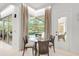Breakfast nook with glass table and chairs, overlooking the pool at 2112 Calusa Lakes Blvd, Nokomis, FL 34275