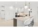 Contemporary kitchen with white cabinets, large island, and breakfast bar at 2112 Calusa Lakes Blvd, Nokomis, FL 34275