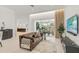 Spacious living room with leather sofa and large TV at 2112 Calusa Lakes Blvd, Nokomis, FL 34275