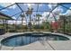 Relaxing kidney shaped pool and spa with screened enclosure at 2112 Calusa Lakes Blvd, Nokomis, FL 34275