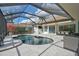 Relaxing kidney-shaped pool with spa, under a covered patio at 2112 Calusa Lakes Blvd, Nokomis, FL 34275