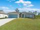 Charming single-story home with a two-car garage and landscaped front yard at 2842 Escambia Cir, North Port, FL 34288