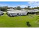 Large green lawn surrounding a single-story house with a tiled roof at 3325 Spring Mill Cir, Sarasota, FL 34239