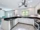 Modern kitchen with stainless steel appliances and breakfast bar at 4001 Beneva Rd # 409, Sarasota, FL 34233