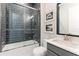 Clean bathroom with dark tile and a tub shower combo at 4707 Arpino Ct, Bradenton, FL 34211