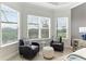 Relaxing sitting area in bedroom with two armchairs and large windows at 4707 Arpino Ct, Bradenton, FL 34211