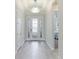 Bright and airy entryway with elegant tile flooring and a unique chandelier at 4707 Arpino Ct, Bradenton, FL 34211