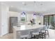 Modern kitchen with white cabinets, quartz countertops, and stainless steel appliances at 4707 Arpino Ct, Bradenton, FL 34211