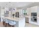 Modern kitchen with white cabinets, quartz countertops and stainless steel appliances at 4707 Arpino Ct, Bradenton, FL 34211