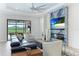 Spacious living room with a stunning fireplace and large screen TV at 4707 Arpino Ct, Bradenton, FL 34211