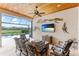 Spacious outdoor living area with comfortable seating and a large TV at 4707 Arpino Ct, Bradenton, FL 34211