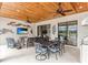 Relaxing outdoor living space with dining and seating areas, ceiling fans, and views at 4707 Arpino Ct, Bradenton, FL 34211
