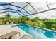 Inviting pool and spa with screened enclosure, offering a relaxing outdoor oasis at 4707 Arpino Ct, Bradenton, FL 34211