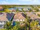 Aerial view of a home with a pool, tile roof, and lush landscaping at 4740 Royal Dornoch Cir, Bradenton, FL 34211