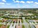 Aerial view of a house in a residential neighborhood with a pond nearby at 4905 Avila Lakes Dr, Wimauma, FL 33598