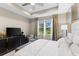 Spacious bedroom with large window and TV at 4905 Avila Lakes Dr, Wimauma, FL 33598