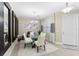 Modern dining room with glass table, white chairs, and statement mirrors at 4905 Avila Lakes Dr, Wimauma, FL 33598