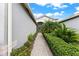 Brick walkway with lush landscaping leading to the front entrance at 4905 Avila Lakes Dr, Wimauma, FL 33598