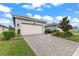 Home with attached garage and driveway at 4905 Avila Lakes Dr, Wimauma, FL 33598