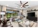 Comfortable living room with sliding doors to backyard and a ceiling fan at 4905 Avila Lakes Dr, Wimauma, FL 33598