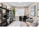 Home office with built-in shelving, a desk, and a comfortable seating area at 4905 Avila Lakes Dr, Wimauma, FL 33598