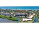 Aerial view showcasing condo building, marina, and surrounding neighborhood at 4960 Gulf Of Mexico Dr # 206, Longboat Key, FL 34228