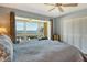 Main bedroom with water views and ceiling fan at 4960 Gulf Of Mexico Dr # 206, Longboat Key, FL 34228