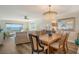 Bright dining room with wooden table and chandelier at 4960 Gulf Of Mexico Dr # 206, Longboat Key, FL 34228