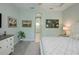 Main bedroom with king bed, ensuite bathroom access, and coastal decor at 5617 Piccolo St, Nokomis, FL 34275