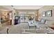 Inviting living area with waterfront views, comfortable furniture, and sliding glass doors to patio at 6029 E Peppertree Way # 116, Sarasota, FL 34242