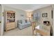 Cozy den/office with a sleeper sofa, desk, and bookshelf at 6029 E Peppertree Way # 116, Sarasota, FL 34242