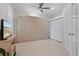 Guest bedroom with a wall bed, TV, and ample closet space at 608 Misty Pond Ct, Bradenton, FL 34212