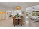 Casual dining area with a round table and wicker chairs near the living room and kitchen at 608 Misty Pond Ct, Bradenton, FL 34212