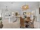 Open kitchen with granite island, white cabinetry, and breakfast nook at 608 Misty Pond Ct, Bradenton, FL 34212