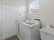 Laundry room with washer, dryer, utility sink, and cabinets at 608 Misty Pond Ct, Bradenton, FL 34212