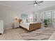 Bright main bedroom with a comfortable bed and large windows at 608 Misty Pond Ct, Bradenton, FL 34212