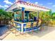 Open-air pool bar with stools and a fully stocked bar at 608 Misty Pond Ct, Bradenton, FL 34212