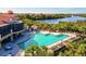 Resort-style pool featuring a bar and lounge area overlooking a scenic waterfront at 608 Misty Pond Ct, Bradenton, FL 34212