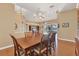 Dining area with wood table, wood floors, and view of the pool through sliding glass doors at 6215 Stillwater Ct, Bradenton, FL 34201