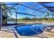 Tranquil pool and spa with screened enclosure and serene water views at 6215 Stillwater Ct, Bradenton, FL 34201